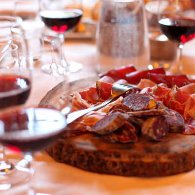 A salumi plate and red wine