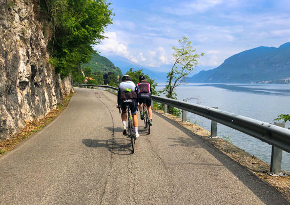 Two riders on the edge of Lake Como