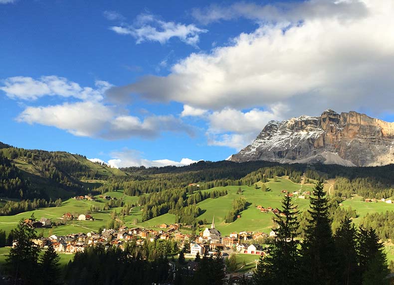 A mountain village with the Dolomites in the background