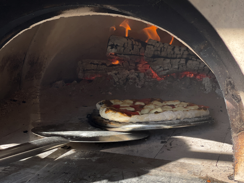a pizza in a wood fired oven