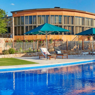 a pool, umbrella and sun lounges