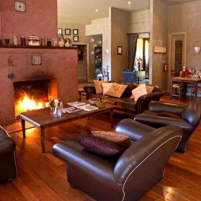 Leather armchairs in front of a fire