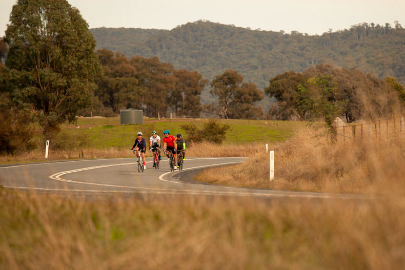 A group of cyclists on the country roads around bright