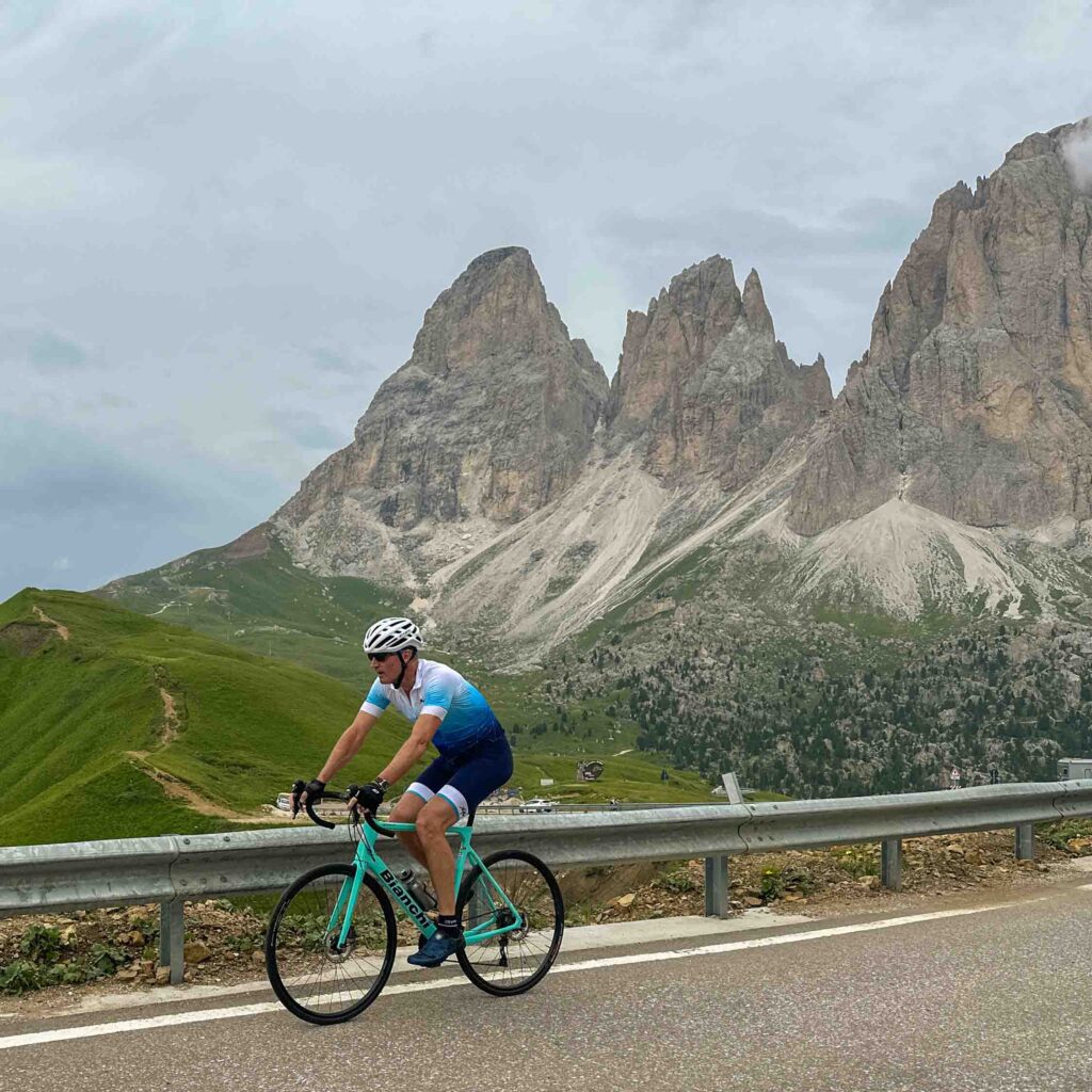 A man cycling in the Dolomites on an Italian cycling tour