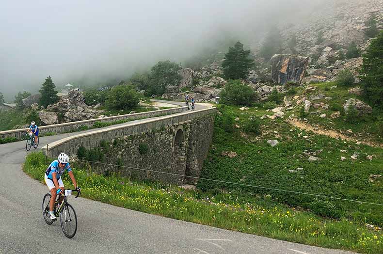 A group of riders cycling up colle Fauniera during La Fausto Coppi Gran Fondo