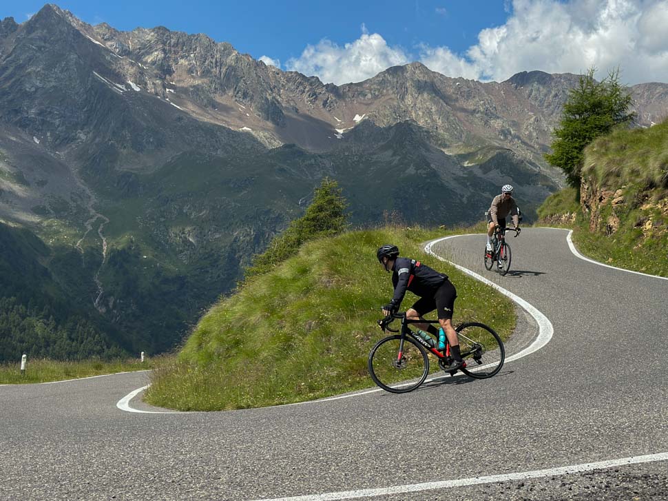 Two bikers riding in the Italian Alps