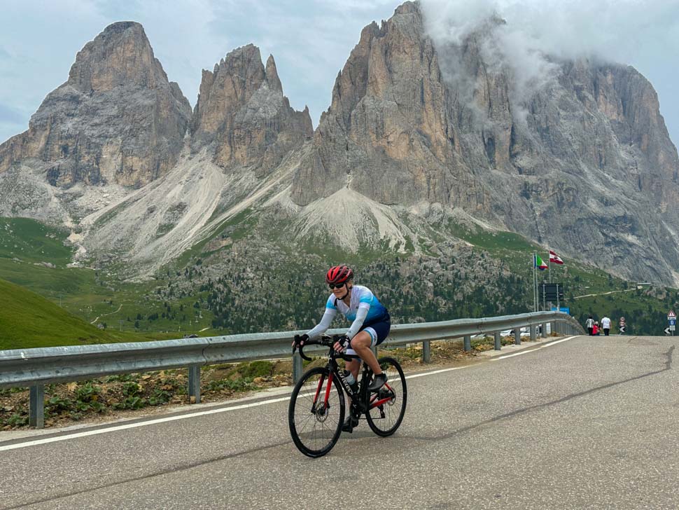 A woman cycling in the dolomites Italy