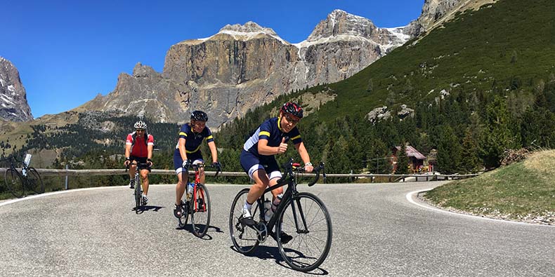 Three cyclist riding the Sella Ronda loop in the Dolomites