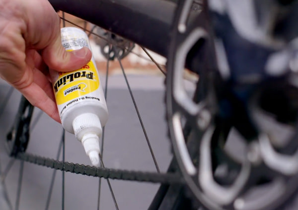bicycle lubricant being applied to a bicycle chain