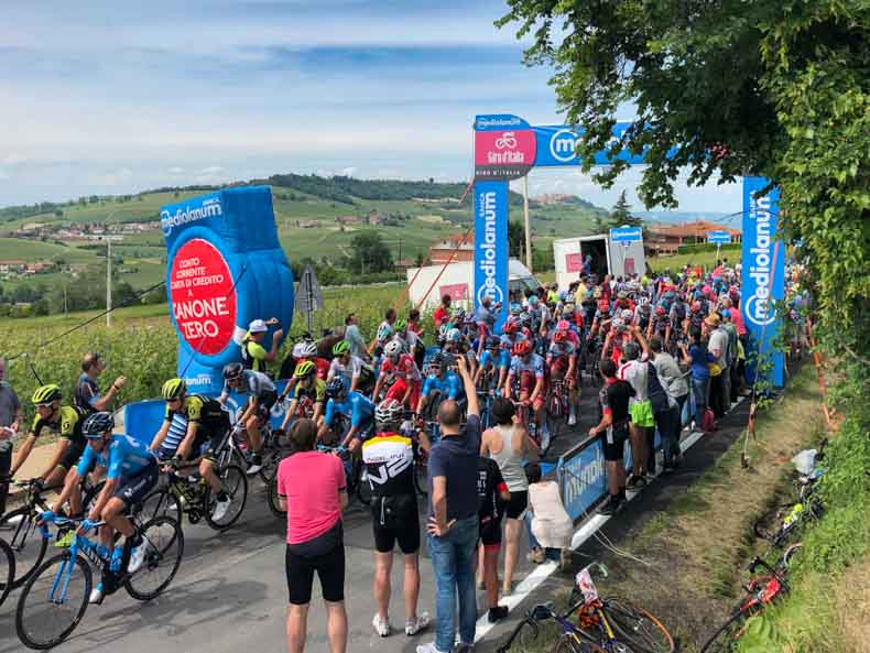 The Giro d'Italia racing over the crest of a hill in Piemonte