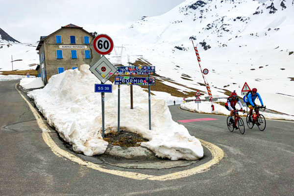 Two cyclist riding to the top of Passo dello Stelvio