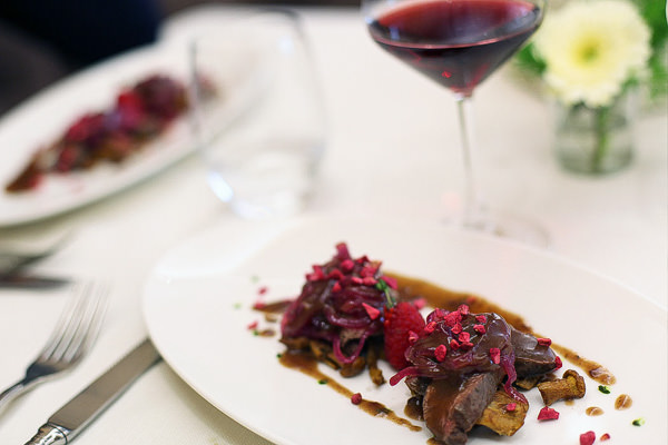 venison chanterelle mushrooms and a glass of red wine