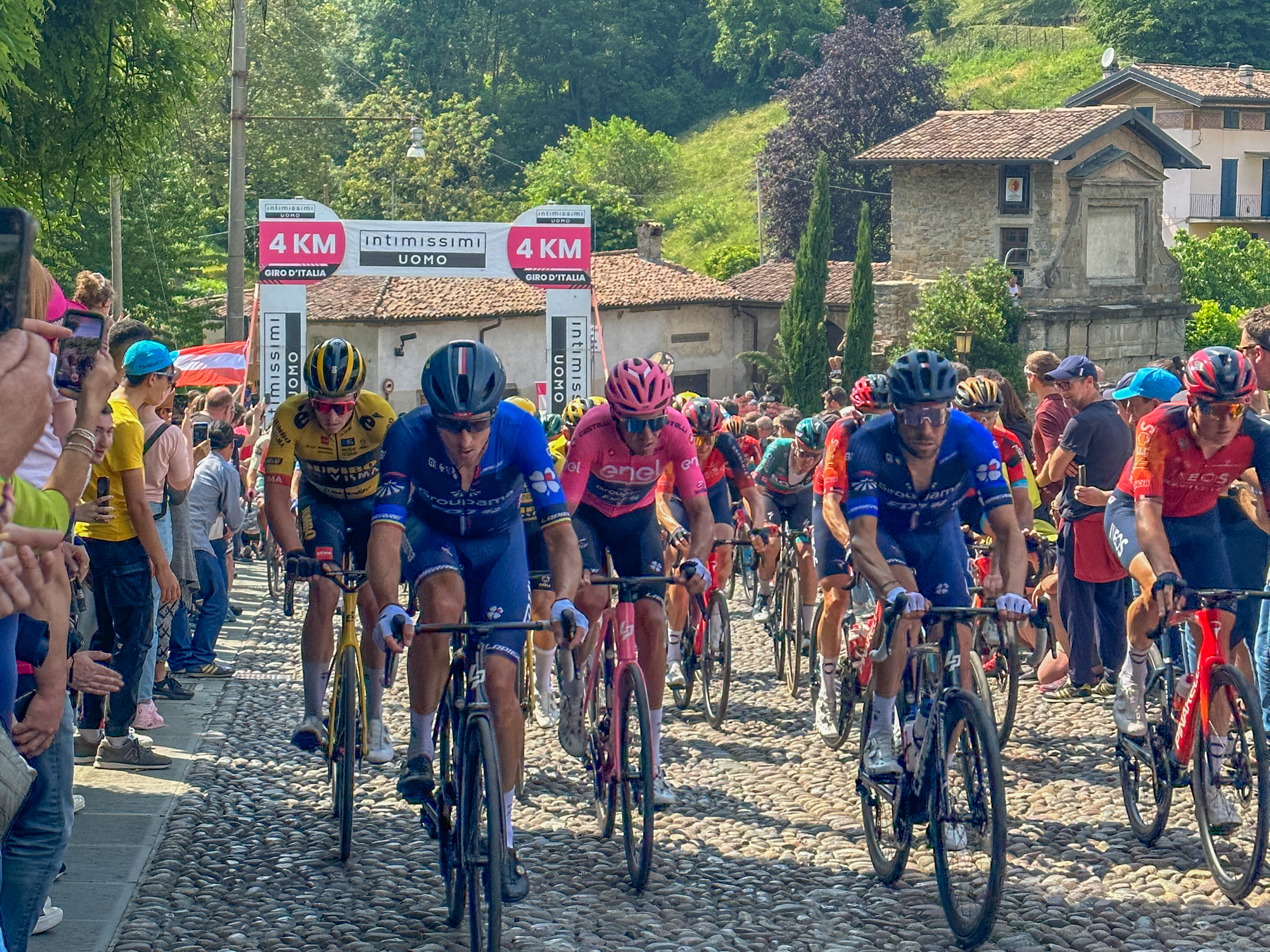 The pink jersey and other cyclists racing in the Giro d'Italia on the outskirts of Bergamo