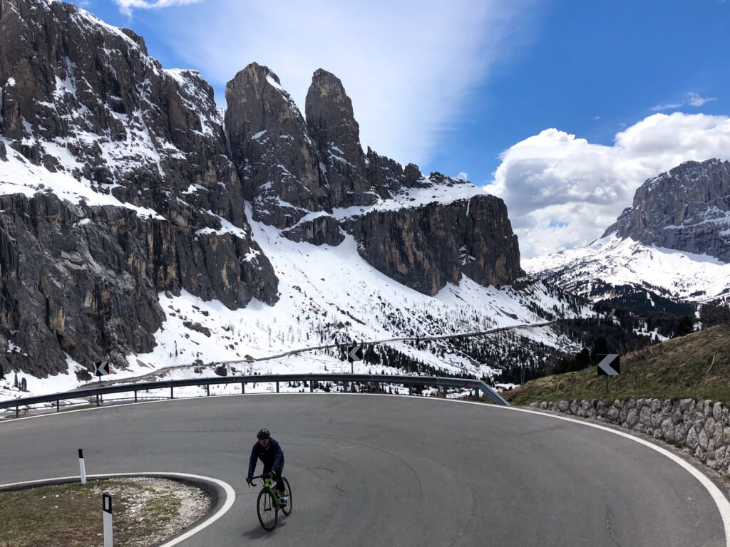 A lone cyclist climbing Passo Sella in the Dolomites