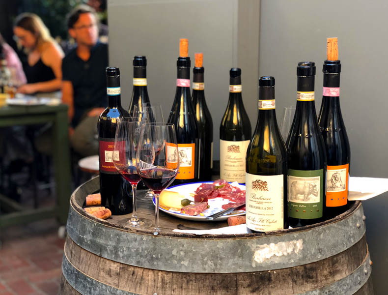 Bottle of Barbaresco on a wine barrel at a wine tasting