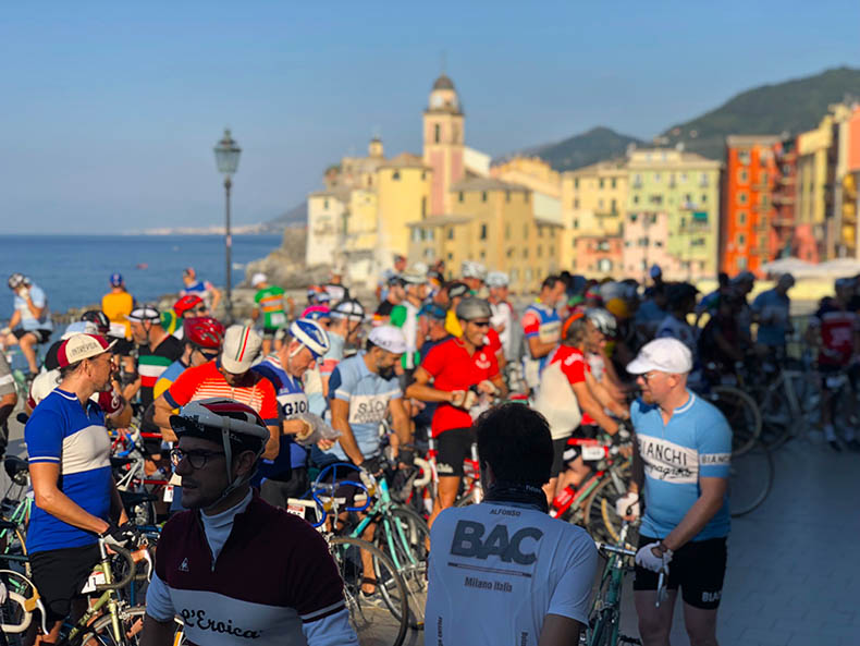 a group of cyclists in vintage woolen jerseys on the ligurian coast