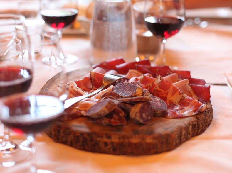 An Italin Salumi board and glass of red wine