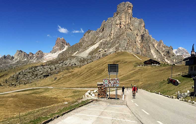 A cyclist riding to the top of Passo Giau on a cycling Holiday