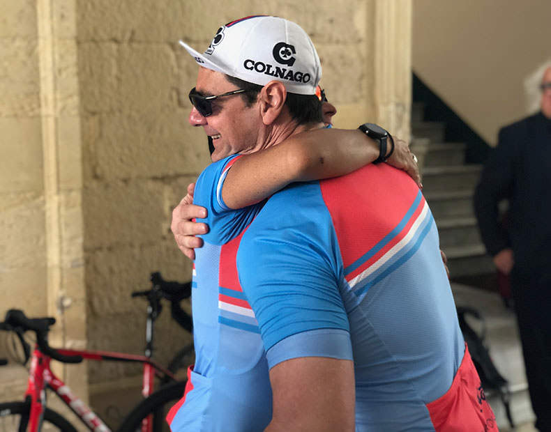 Two people hugging after competing a long bike ride