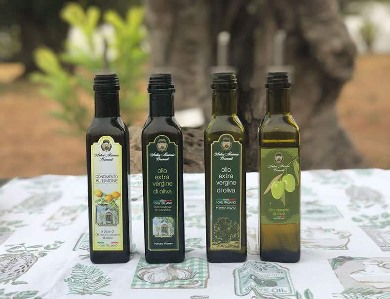 Four bottle of olive oil ona table