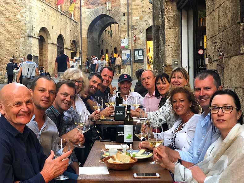a group of people having an afternoon aperitivo in San Gimignano