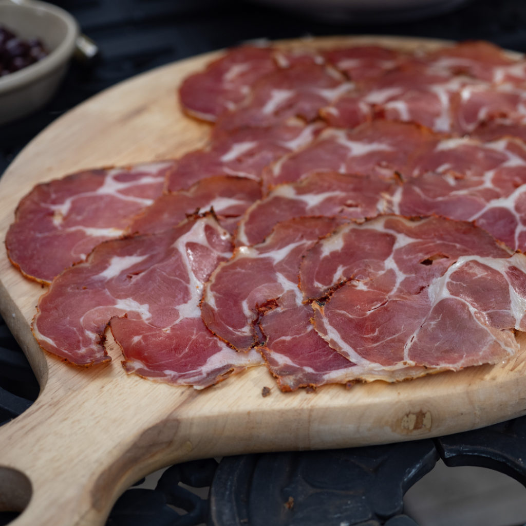 Homemade capocollo on a board