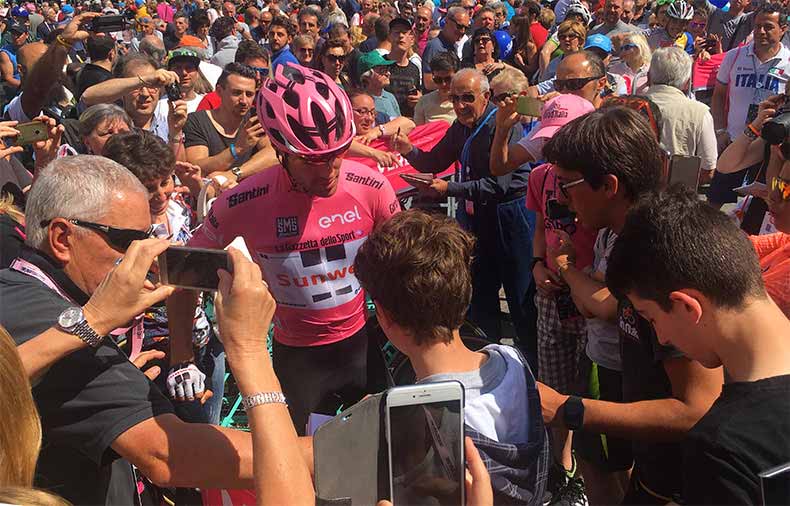 Tom Dumoulin in the Giro pink jersey in the middle of a crowd of people