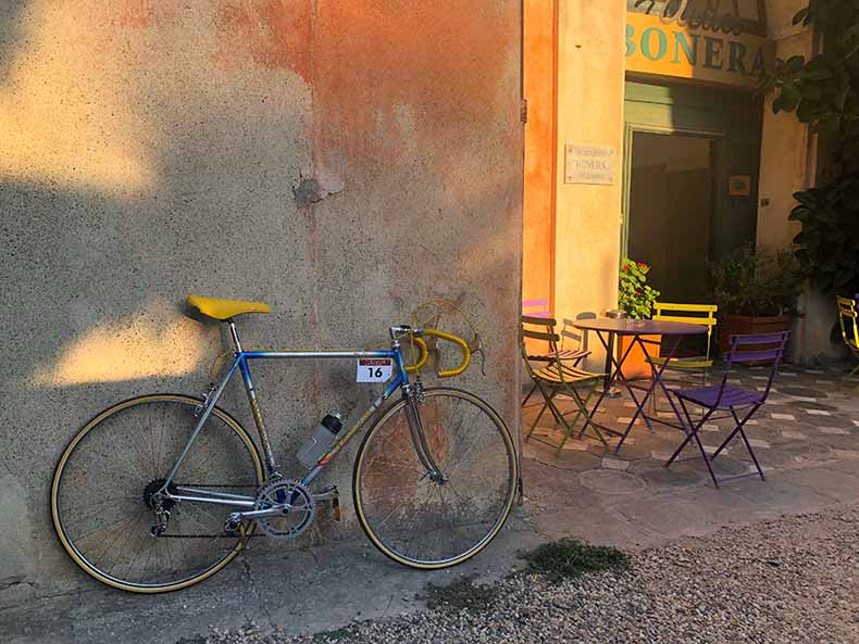 A vintage steel Tommasini bicycle leaning against a wall