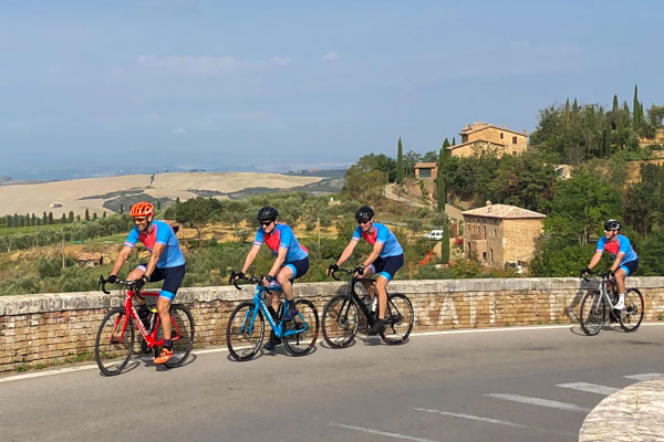 Cyclists riding through the Tuscan landscape on holidays
