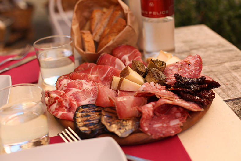 A board filled with salumi and cheese from Tuscany