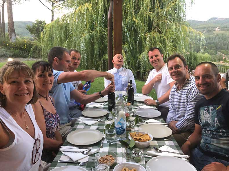 A group of poeple enjoying a dinner in Tuscany