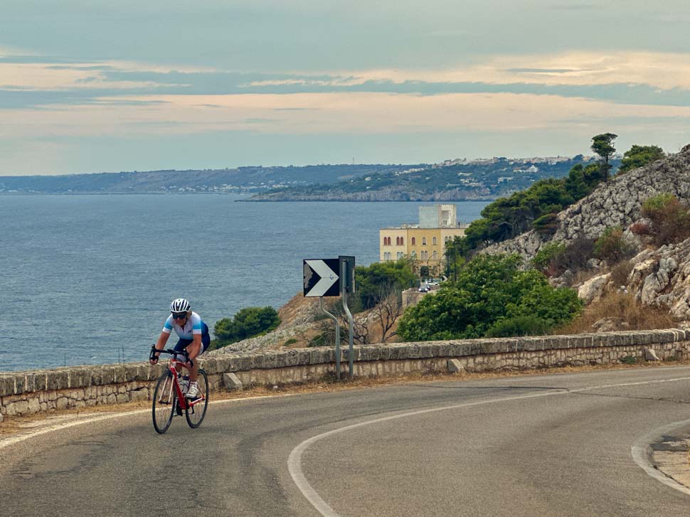 A woman riding along the coastal road of Southern Puglia, Itlaly
