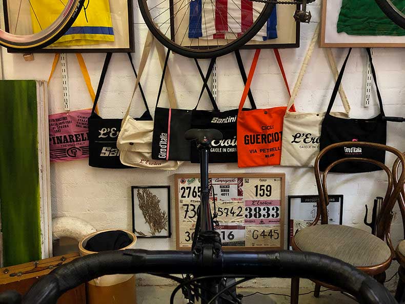 A room with vintage cycling jerseys, musettes and gran fondo ride numbers