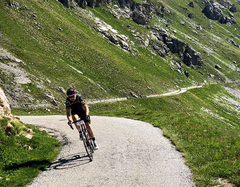 A cyclist descending Colle Fauniera