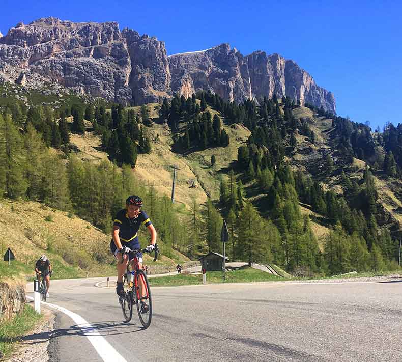 A cyclist riding up Passo Gardena