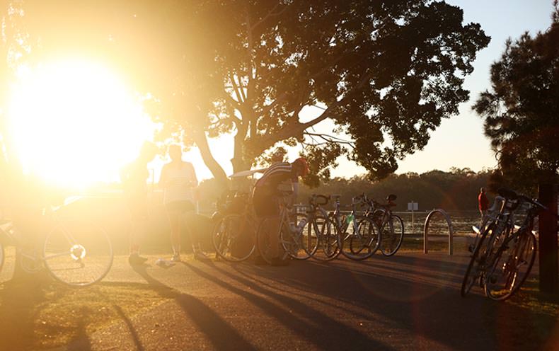 cyclist by a river at dawn waiting to start