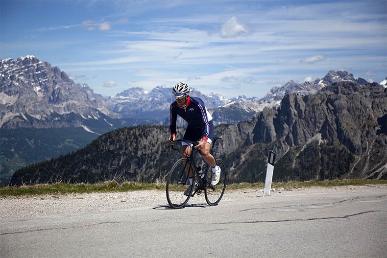 a cyclist riding to the top of Passo Giau
