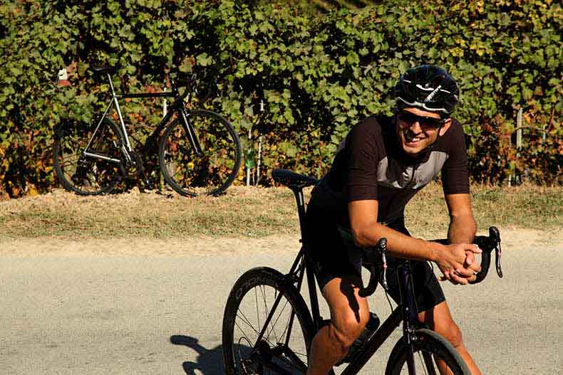 A rider leaning over his bicycle handlebars