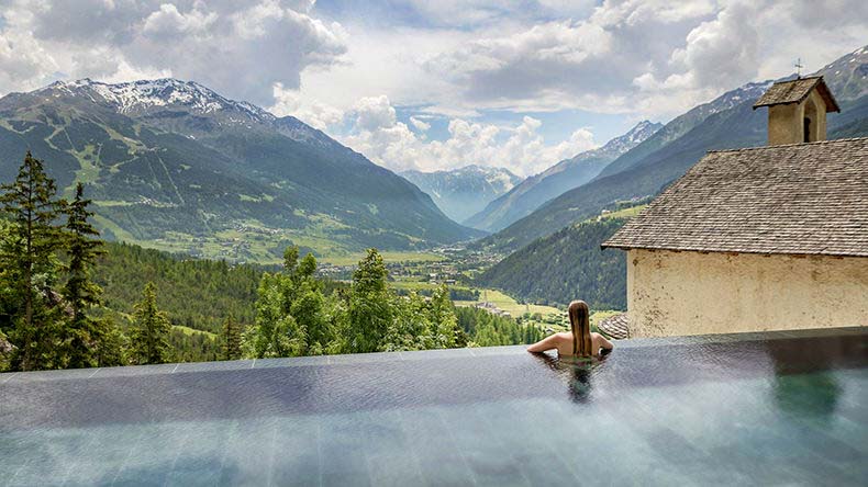 a lady in a thermal spring overlooking Bormio