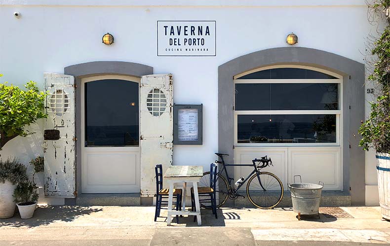 A white washed taverna in Puglia with a bicycles out the front