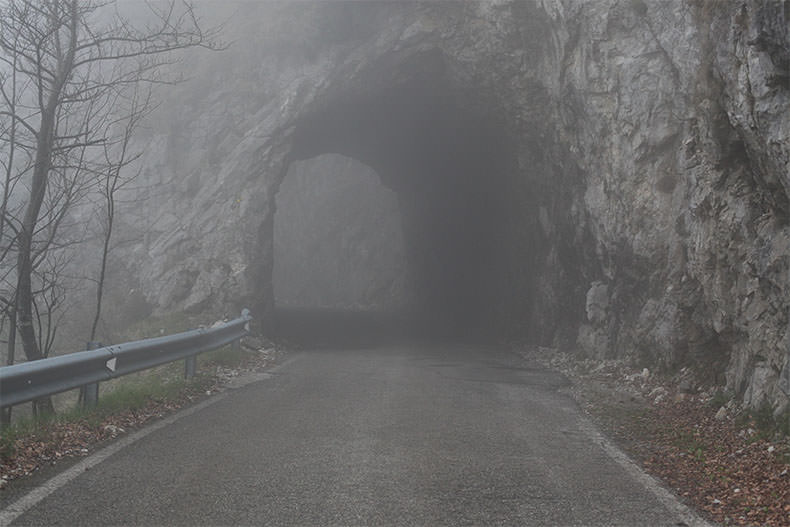 A tunnel on the foggy road up Monte Grappa