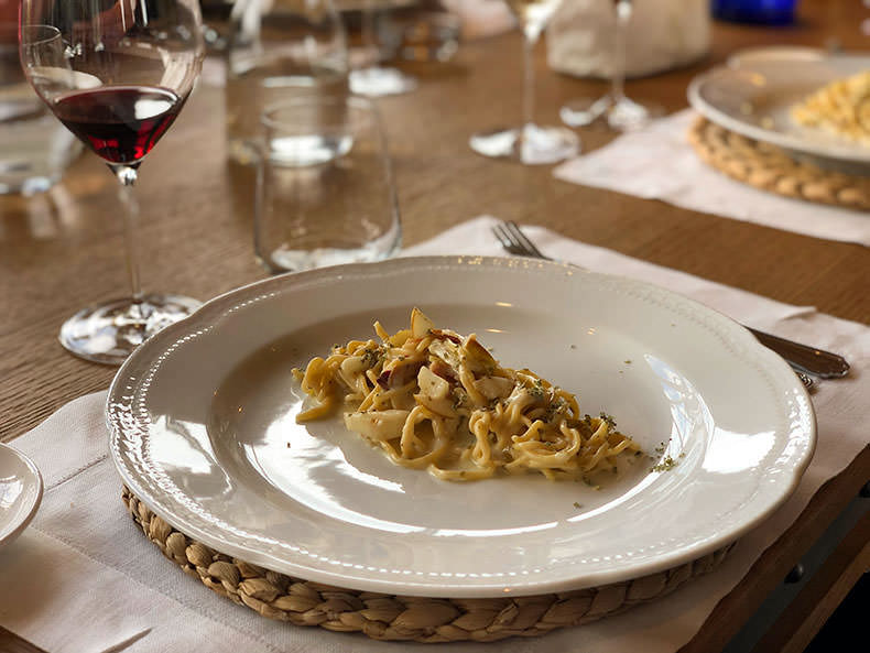 A plate of pasta and a glass of red wine in Tuscany