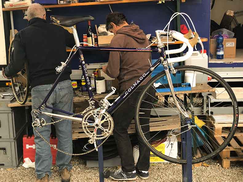 A mechanic fixing a bicycles during L'Eroica