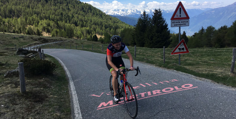 A woman cycling to the top of Mortirolo