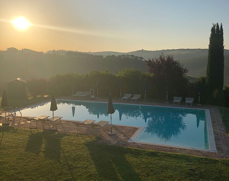 Sunrise over a pool in Tuscany