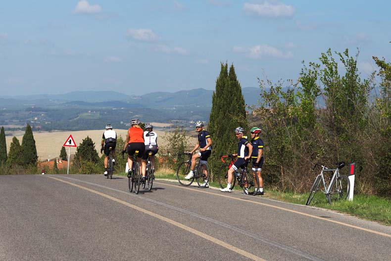 A group of riders on the side of the road in Tuscany