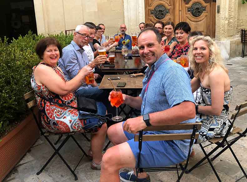 A group of cyclist having aperol spritz at aperitivo in Lecce puglia