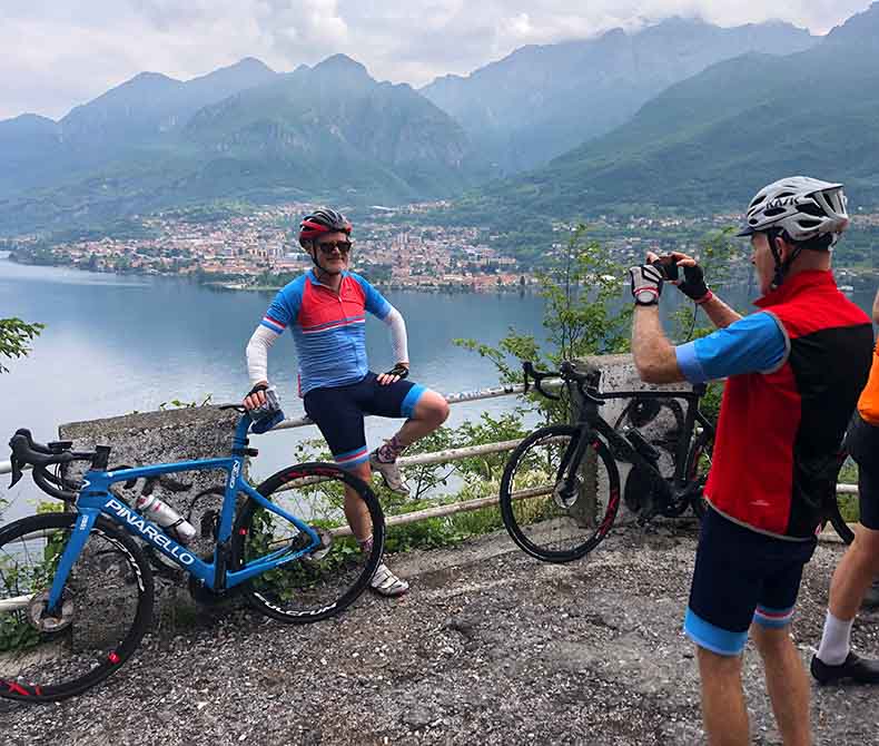 cyclists taking photos of lake como