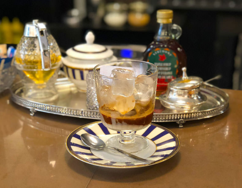 A tray with a glass filled with Caffe Leccese