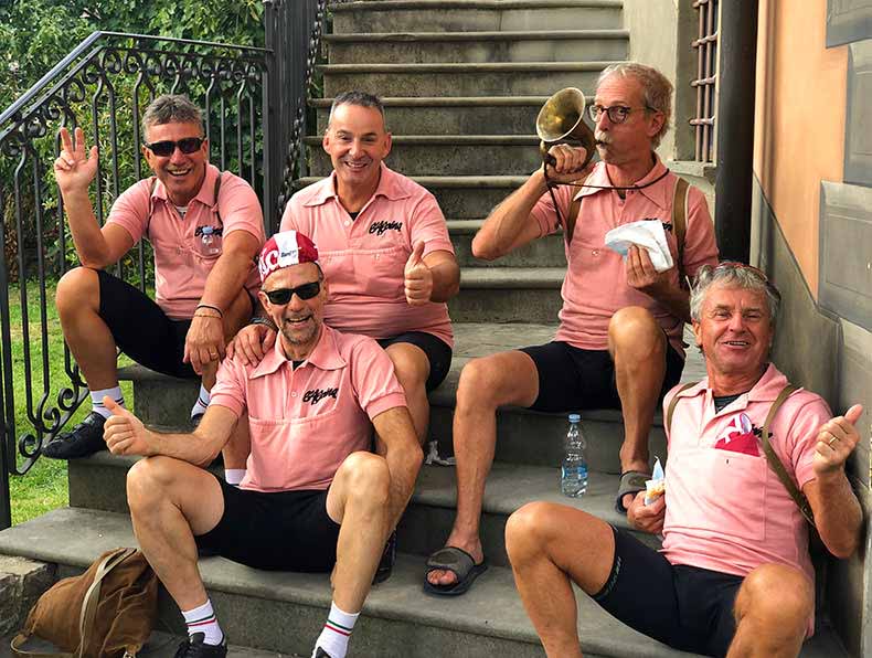 Fiver riders at L'Eroica sitting on a step